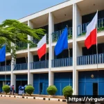 Home 20 기니에서 주재하는 외국 대사관 및 영사관 정보 - A detailed, vibrant scene of a modern embassy building in Conakry, Guinea, showcasing a French embas...